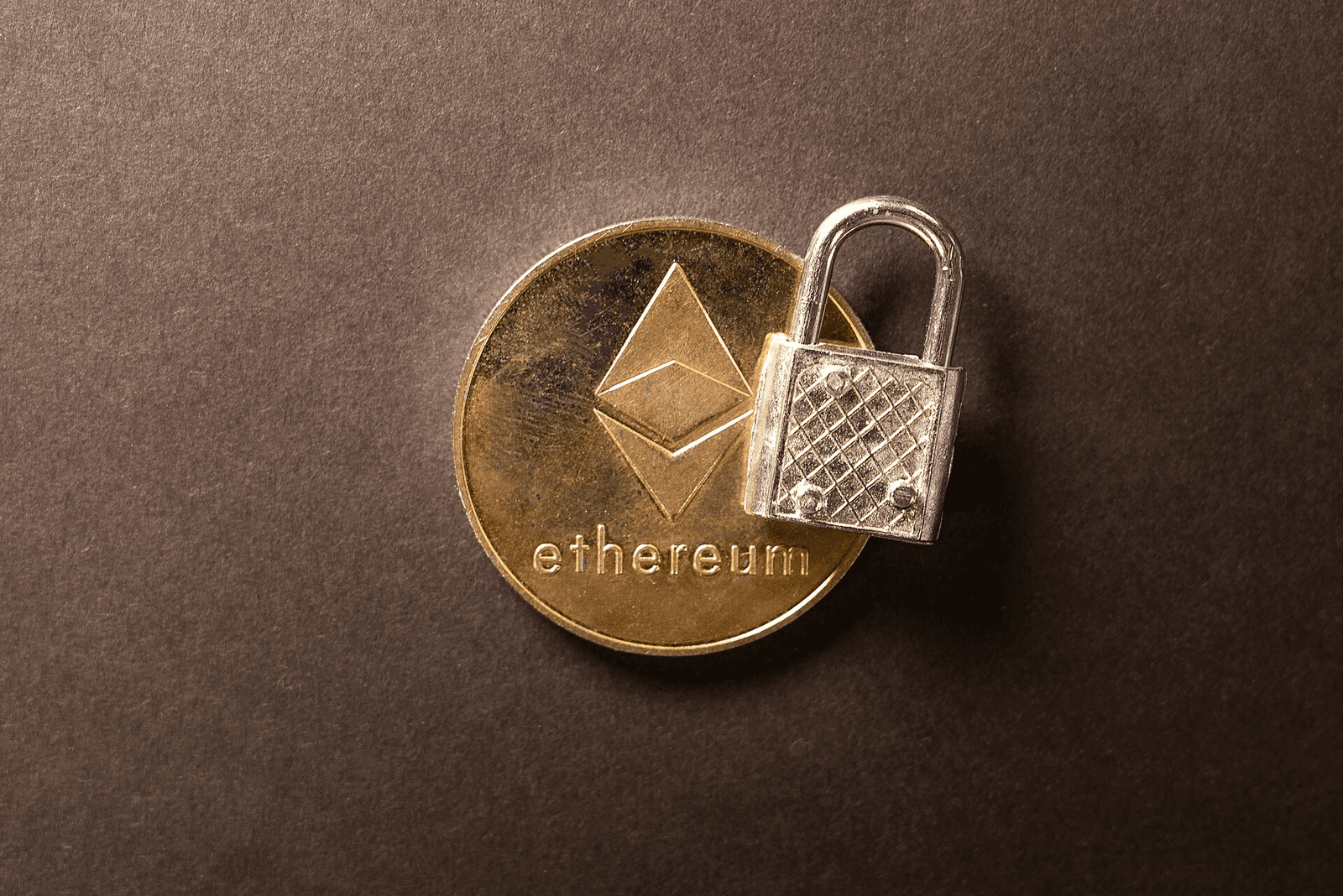 Photo of an Ethereum cryptocurrency medallion alongside a padlock, used to represent the concept of crypto security relating particularly to Ethereum crypto. This image has been released under the Attribution Creative Commons licence, which means you can use the image as long as you credit https://www.bybit.com/en-US/ with ownership of the image with a link.