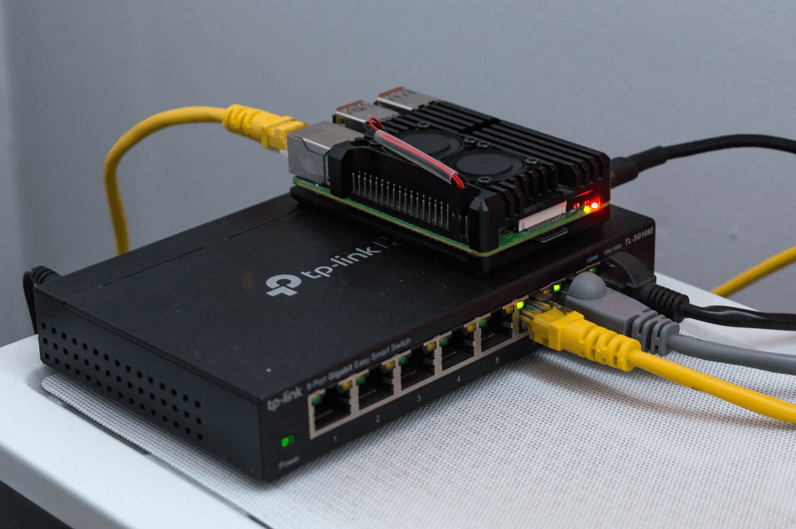 Raspberry Pi 4 model B sitting on top of a TP-Link TL-SG108E managed network switch